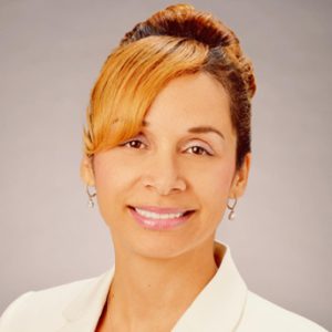 Headshot of Dr. Deme Hill smiling forward wearing a white collared shirt